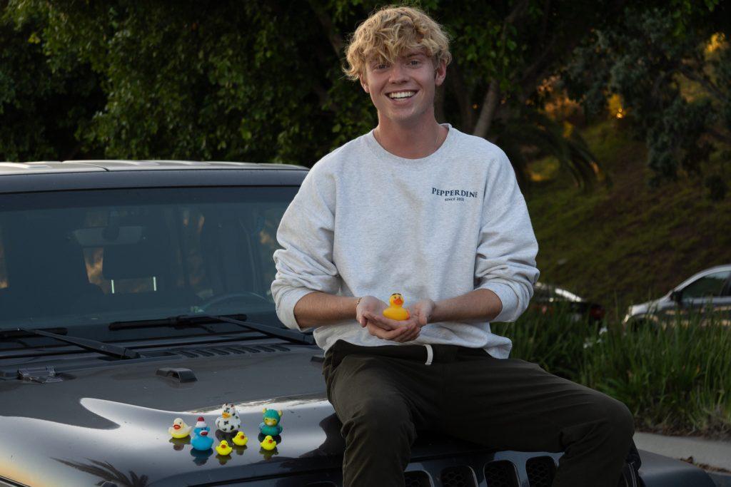 Liam Zieg shows off his rubber duck collection on campus Oct. 5. A new tradition among Jeep owners consists of placing rubber ducks on fellow Jeeps, commonly known as "ducking," according to an article by Parade. Photo by Olivia Schneider