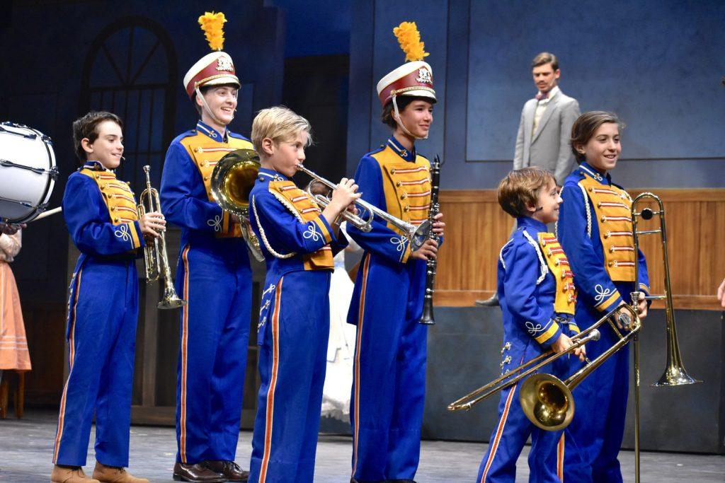 Boys in Harold&squot;s "Boys Band" line up to play their new instruments. Hill and Marian fall in love and the small Iowa town comes to love them both.