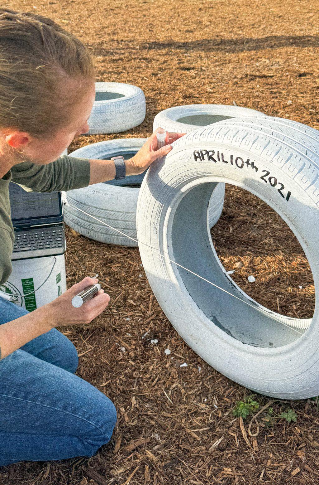 Kylea-Rose Kevitt examines her writing on a ghost tire, Nov. 18. Kylea-Rose's husband Damian Kevitt almost died in 2013, when he was hit by a car while cycling in Griffith Park.