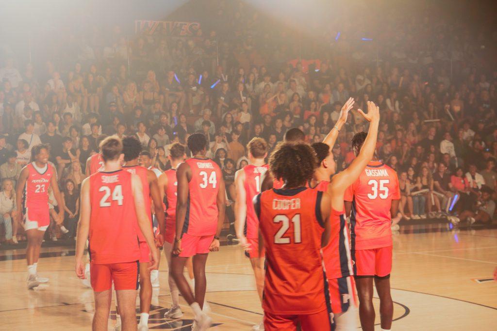 The Men's Basketball team takes the floor to begin rallying the crowd at Blue and Orange Madness in Firestone Fieldhouse on Oct. 7. The men's team includes a number of new recruits and freshman players who look to contribute to winning this upcoming season. Photo by Lindy Smith