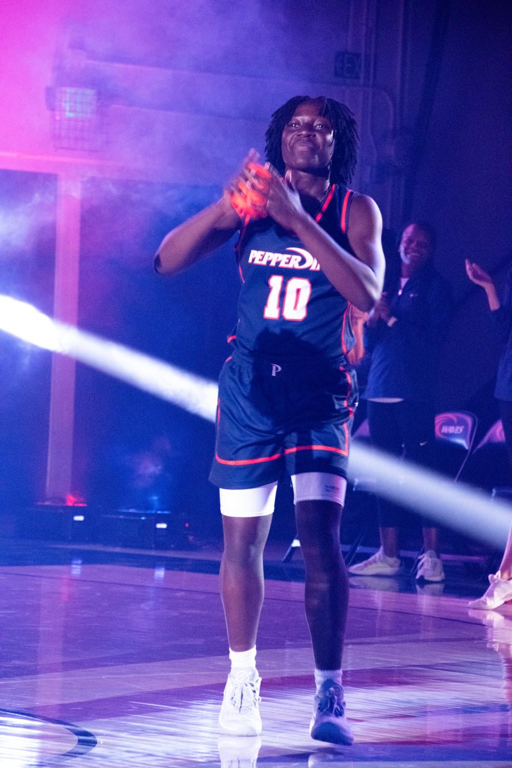 Senior guard Jane Nwaba is introduced to the court, getting ready to throw a free T-shirt to a lucky fan in the stands. Blue and Orange Madness begins with each team's introductions, which sets the tone for the rest of the night. Photo by Perse Klopp