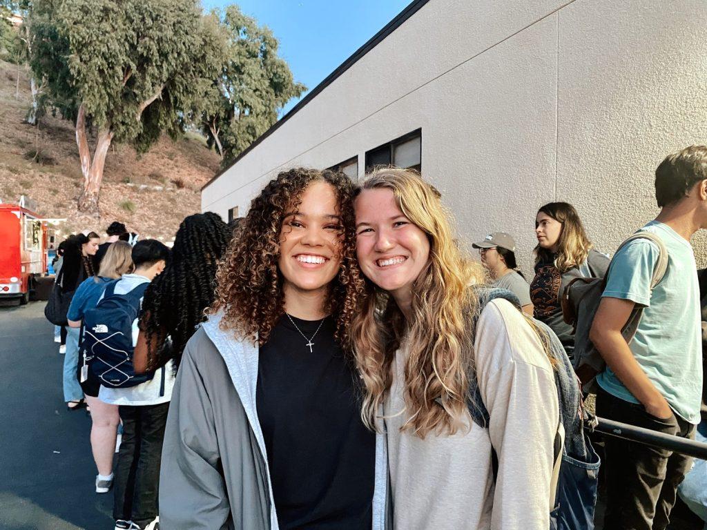 Seniors Olivia Noell Baker and Faith Harcus wait in line outside of the SHC to get their flu shot at Stick-or-Treat. Noell Baker and Harcus were crossing their fingers they'd be part of the first 100 to get a Halloween-themed Charlie Brown crewneck.
