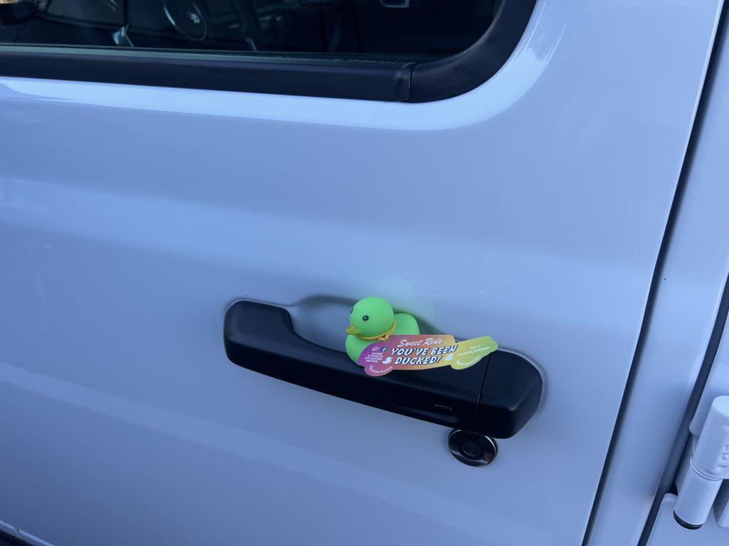 Christina Carroll's first Jeep duckling sits on her door handle Oct. 1. Carroll now keeps her little green duck in her center console. Photo courtesy of Christina Carroll