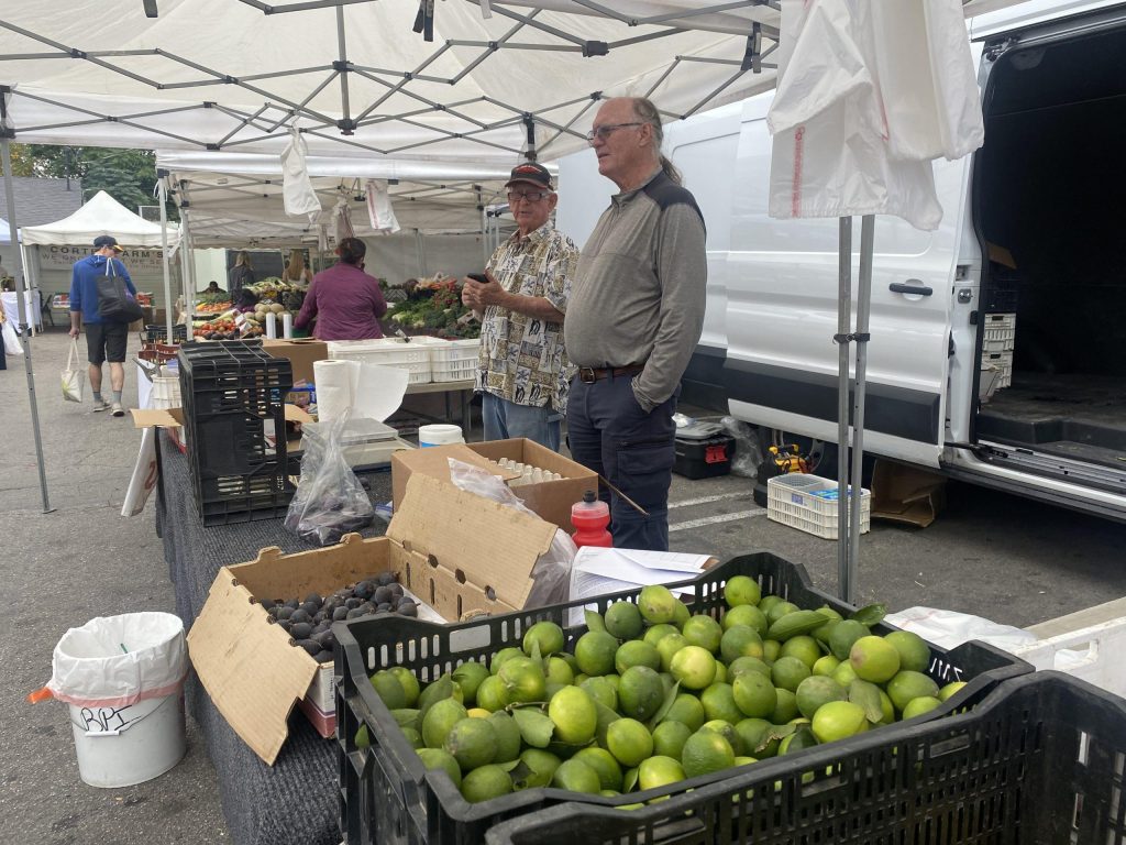 Farmer Gene Etheridge works at the Calabasas Farmer's Market on Sept. 30. Ethridge said being on earth for 76 years he has seen a lot of change, but believes people can come together to fight Climate Change. Photo by Samantha Torre