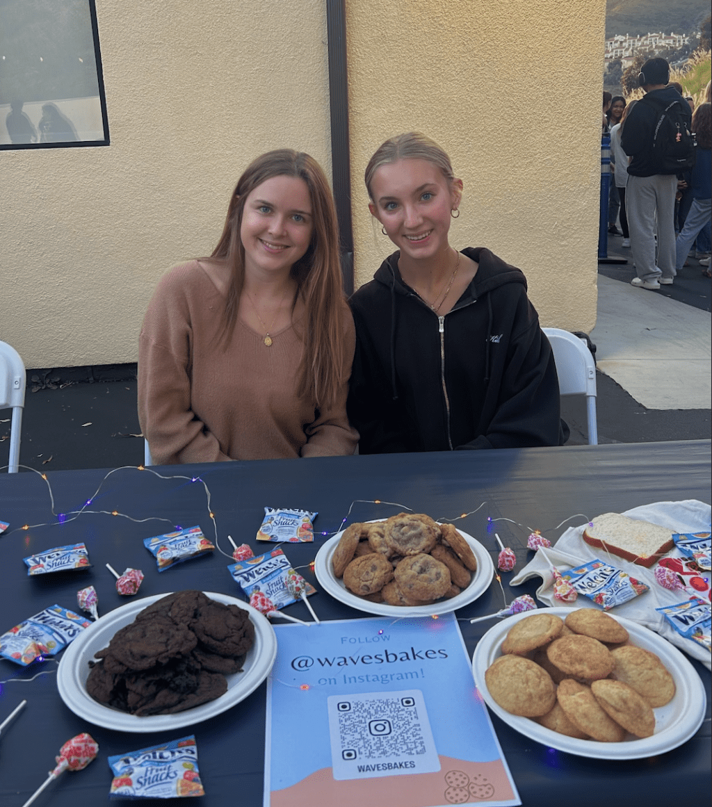 Lily Wilson (Left) and Taylor Karr (Right), owners of Waves Bakes, table at SWAB's Stick or Treat event. Students were able to try free samples after receiving a flu shot. photo courtesy of Taylor Karr