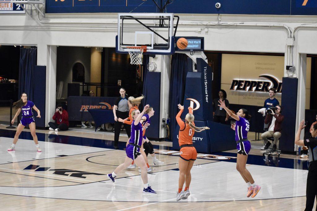 Junior guard Addi Melone pulls up for a 3-point shot against Portland at Firestone Fieldhouse. Melone took three of the nine three-point attempts for the Waves.
