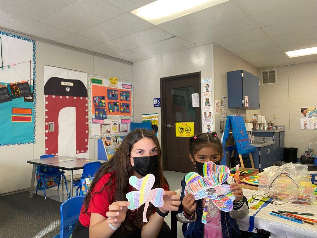 Kelsey Carlton and a Jumpstart student show their art projects to the camera at Vanalden Elementary School on Feb. 11, 2022. Jumpstart works with children from underserved communities, according to the Pepperdine Jumpstart website. Photos courtesy of Kelsey Carlton