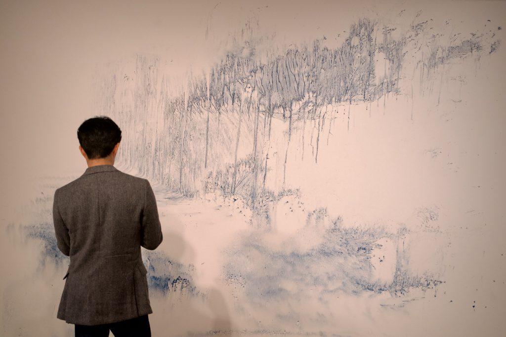 An observer stands in front of "Walking on Water — Forest" on Jan. 20, in the Weisman Museum. This painting was a display of blue beauty made of pulverized azurite. Photos by Liam Zieg