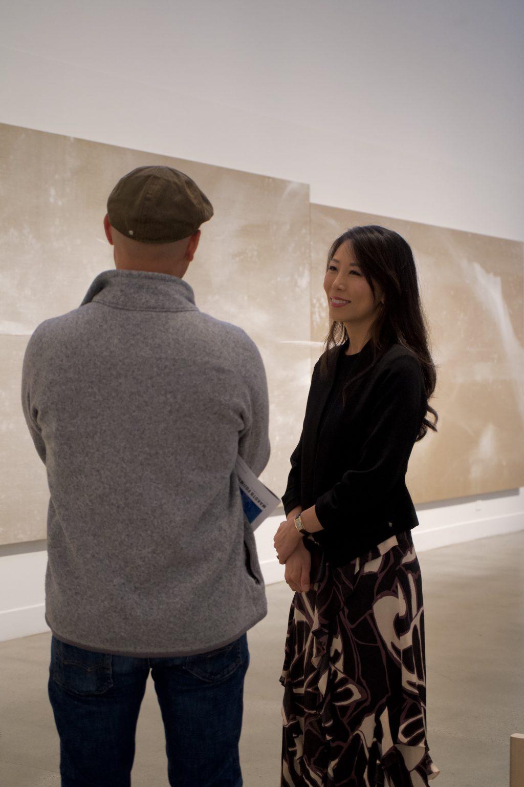 Haejin Fujimura speaks with an observer in front of "Sea Beyond" in the Weisman Museum on Jan. 20. She founded Embers International, an international program and advocacy agency — fighting exploitation, and human trafficking in India, according to the their website.