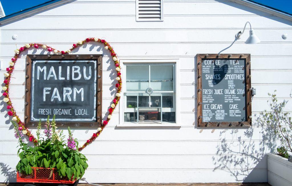 A bright farm-style building displays Malibu Farm's famed chalkboard sign on Feb. 11. Located at the Malibu Pier, this restaurant has captured the interest of thousands of visitors due to its' prime location on the water and popularity on social media according to the L.A. Times.