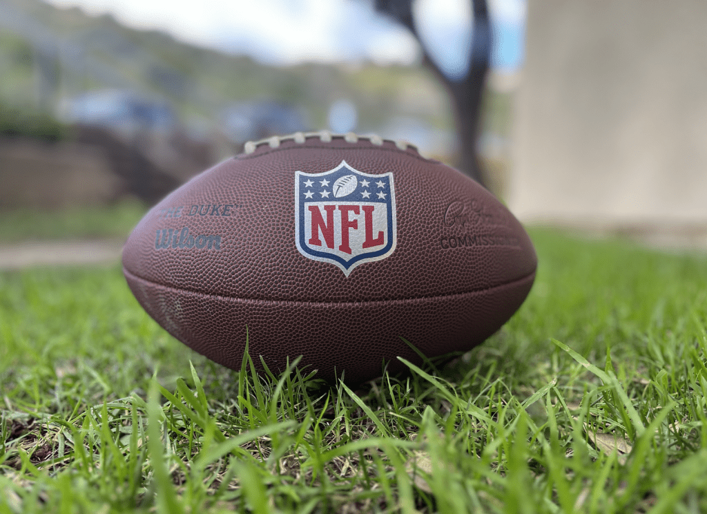 A football sits in the grass outside of the Pepperdine dorms. The NFL plays tackle football — a sport parents, coaches, players and policymakers are debating the consequences for those under 12 years of age. Photo by Tony Gleason