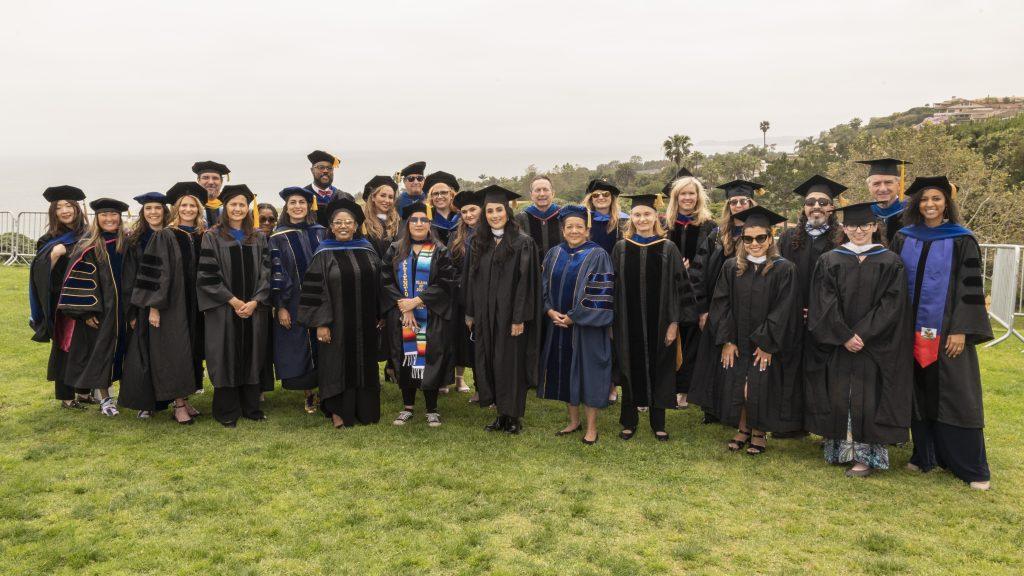 Pictured second from the left, Dr. Elizabeth Fong gathers with faculty from the Graduate School of Psychology and Education at the 2023 commencement on Alumni Field. Fong was a leading contributor in the field of Behavior Analysis, many faculty members said. Photo courtesy of Vanessa Jahn