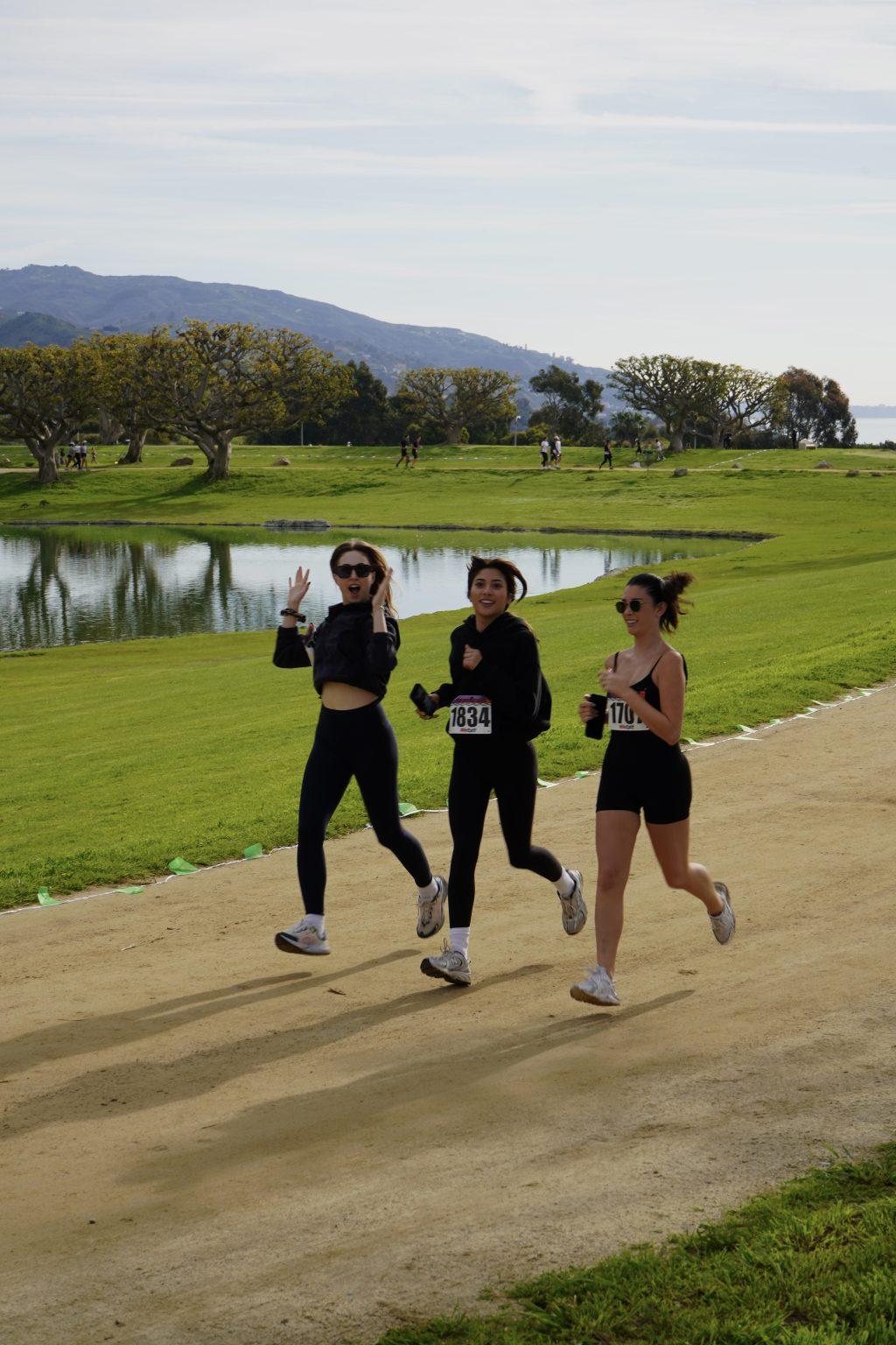 Participants Grace Teague, Fiona Hernandez and Mimi Thomas (left to right) run the grass and dirt course together March 10. The morning was brisk but lively.