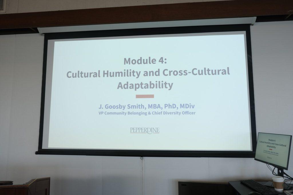"Module 4: Cultural Humility and Cross Cultural Adaptability" is presented on the screen in the Fireside Room on Feb. 22. This was the first slide in a cultural competency presentation curated for this seminar.