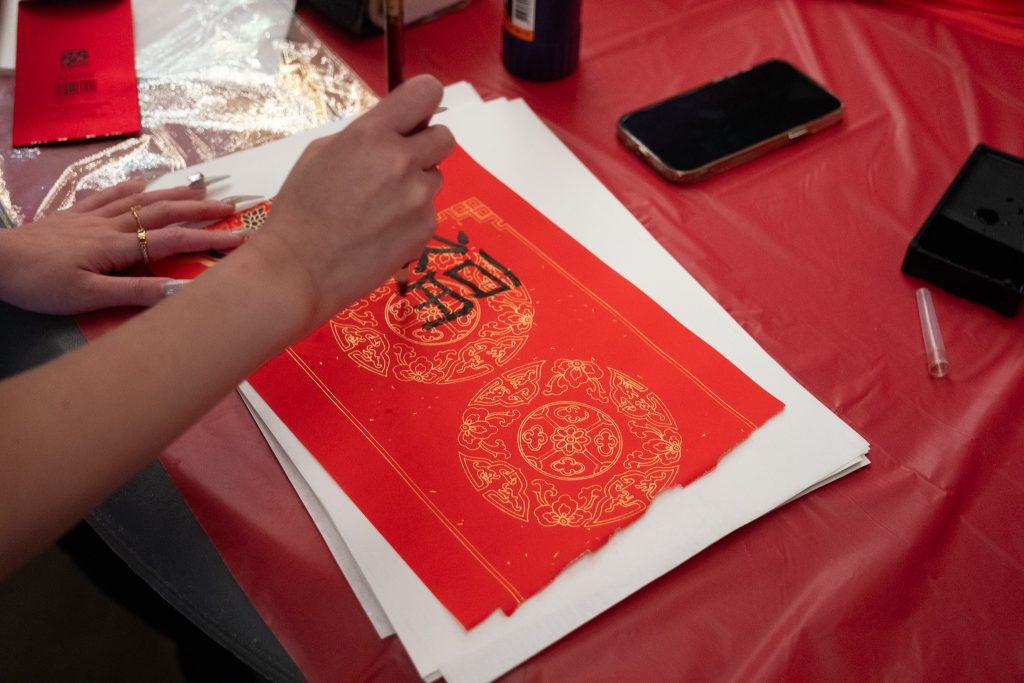 The Chinese Student and Scholar Association celebrated the Year of the Dragon by hosting their 2024 Chinese New Year Gala in the Light House on Feb. 2. Students participated in multiple activities such as writing Chinese Calligraphy. Photos courtesy of Xide Peng
