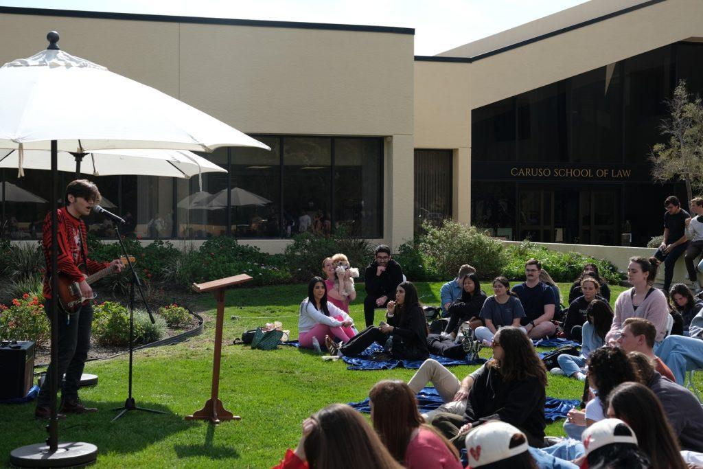 Caruso School of Law students sit on the front lawn watching one of the acts perform during the talent show Feb. 14. Students and faculty gathered around to watch the students perform. Photo courtesy of Nikiko Burnett