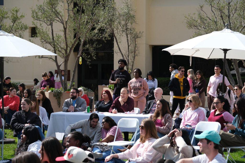 The talent show judges watch the performers on the front lawn of the Caruso School of Law on Feb. 14. The judges were engaged in each performance. Photo courtesy of Nikiko Burnett