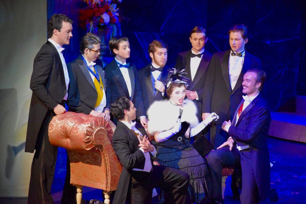 Admirers and potential suitors surround Hannah Glawari, the merry widow, played by junior Payton Ballinger on Feb. 24, in Smothers Theatre. Hannah inherited her late husband's fortune and many sought her wealth. Photos by Mary Elisabeth