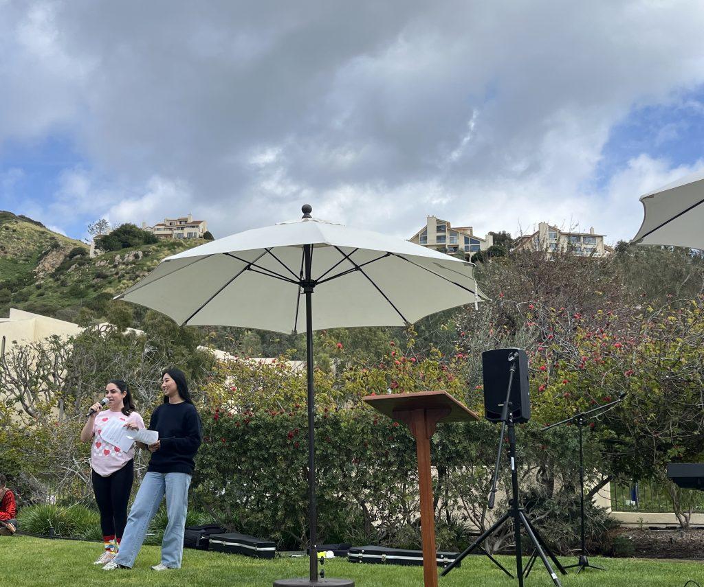 SBA members Melanie Ohanian and Ashley Pae host the Valentine's Day talent show Feb. 14, on the front lawn of Caruso School of Law. The two members introduced each contestant and engaged with the audience. Photo by Viviana Diaz