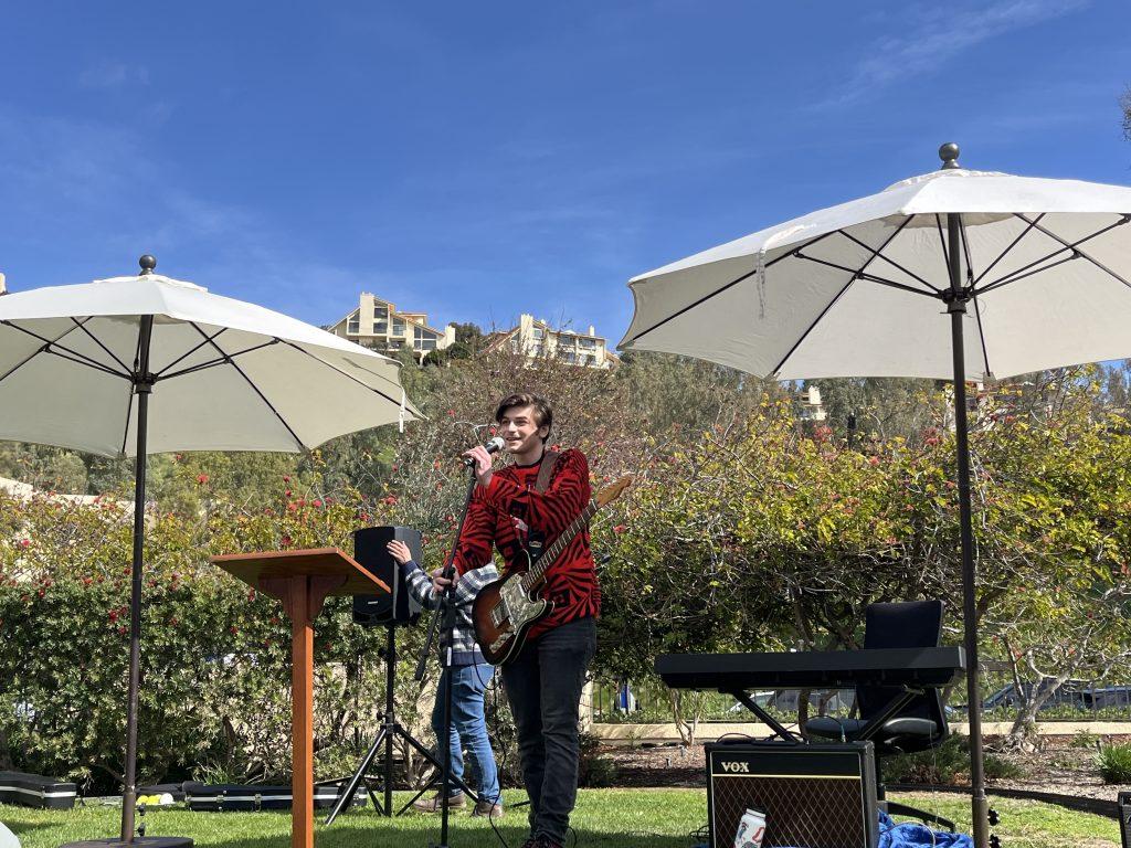 Aren Ekizian sings with his guitar on the front lawn of the Caruso School of Law on Feb. 14. Ekizian got the crowd to dance and sing as he performed "This Charming Man" by The Smiths. Photo by Viviana Diaz