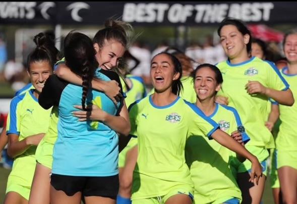Parsio jumps into the arms of her teammates as they celebrate a penalty-shoot-out win at the Surf College Cup in Nov. 2021. In high school, Parsio was the Captain of the soccer team for two seasons, leading the team in goals and assists. Photos courtesy of Jenna Parsio