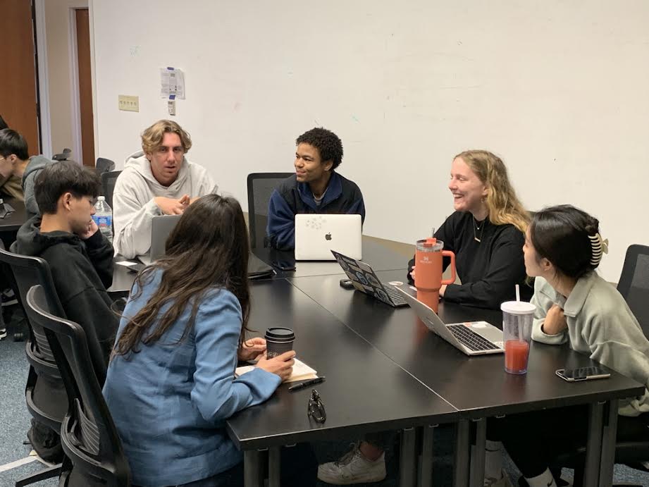 Pepperdine finance students working on a project in fall 2023. Visiting Professor of Finance John Ned said his general advice for graduating seniors is to enjoy life and embrace the journey ahead. Photo courtesy of John Ned