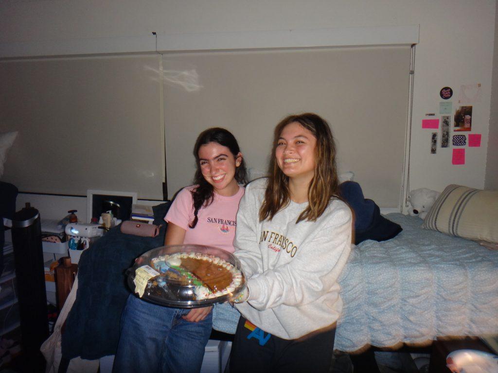 Amanda Monahan (right) and her roommate, Amanda Mola (left), hold a cookie cake in their DeBell dorm room Feb. 11. "The Amandas" have taken various adventures together, whether it&squot;s hosting watch parties in their room or trying new coffee shops. Photos by Amanda Monahan