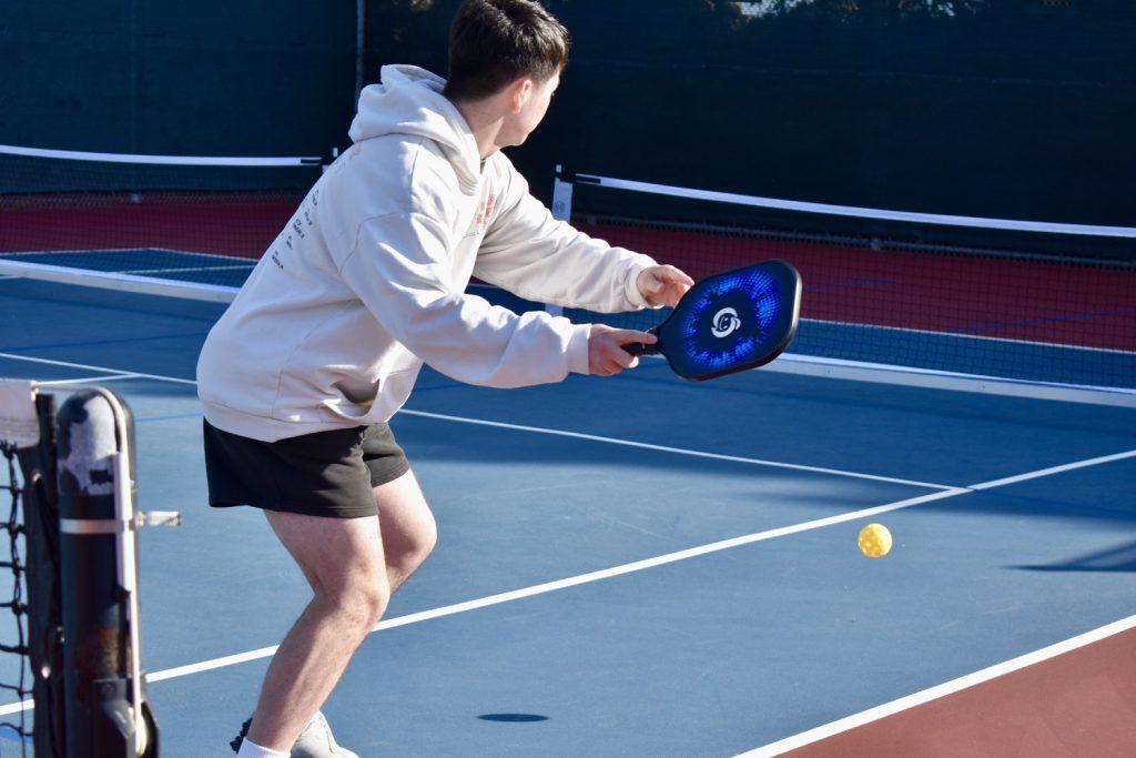 Junior Ryan Hsiao prepares to receive a ball in the middle of an open play session Feb. 10, at Lower Alumni Courts. Pepp Pickle posted their meeting schedule Feb. 7, on their Instagram. Photo by Mary Elisabeth