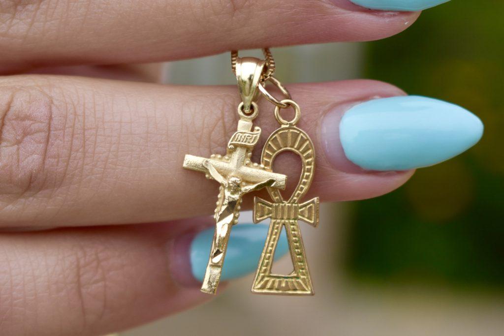 Senior Melanie Tadros holds jewelry symbolizing her Coptic Orthodox Christian heritage. Tadros said college is a time for her to branch out and discover her faith. Photos by Mary Elisabeth
