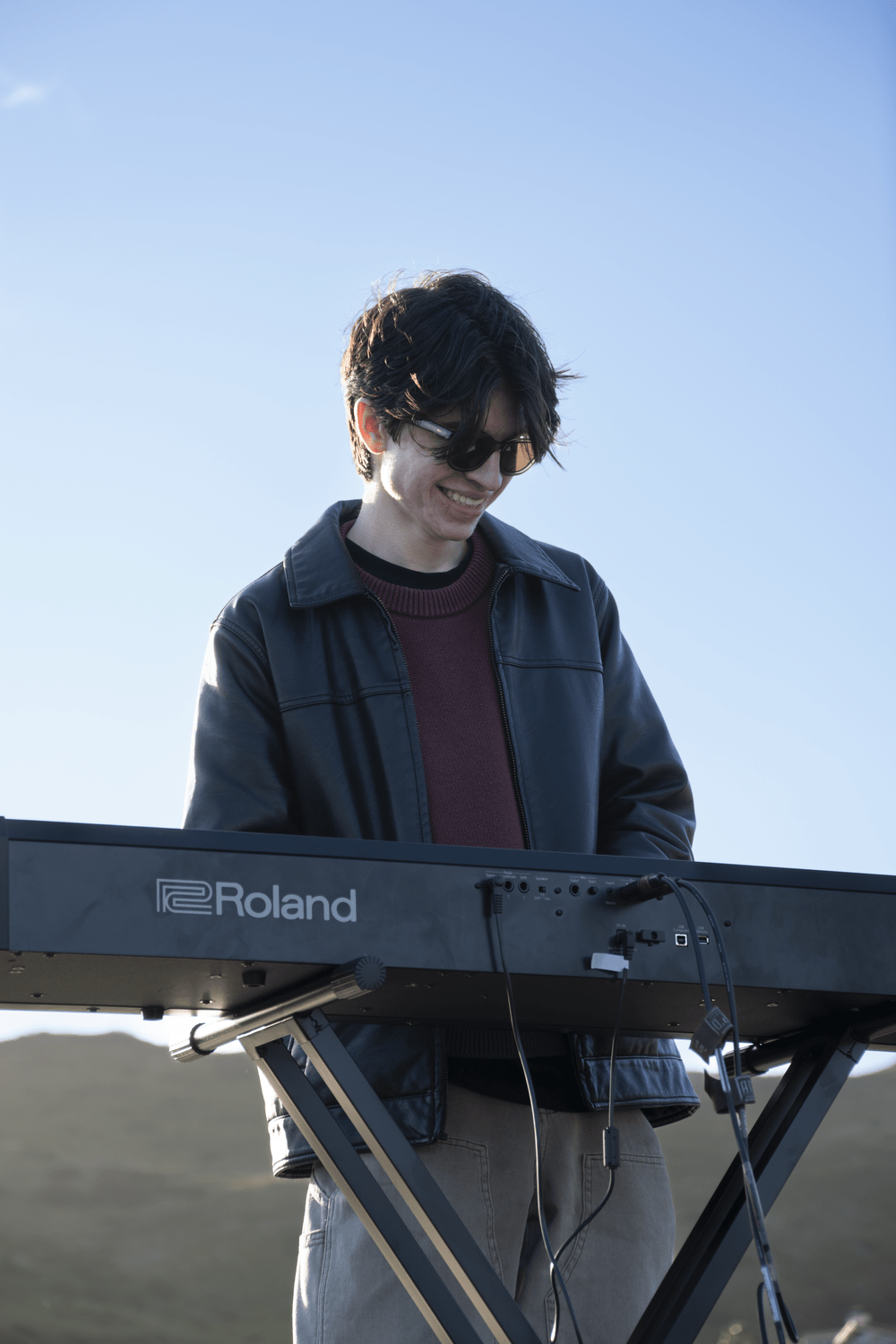 Junior Evan Herrera plays the keyboard for Press Play Septet March 23, at Alumni Park. Herrera helped start the student band.