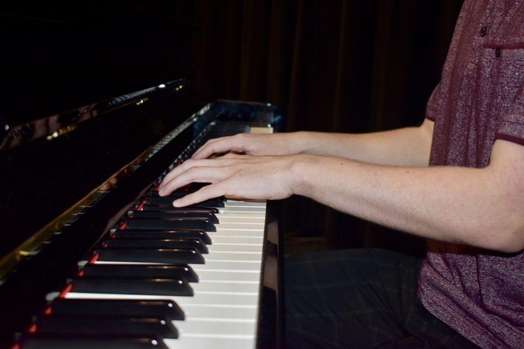 Senior Jackson Murrieta plays the piano onstage in Smothers Theatre. Murrieta said the training he received as a member of Pepperdine's theater department came into play at work. Photo by Mary Elisabeth