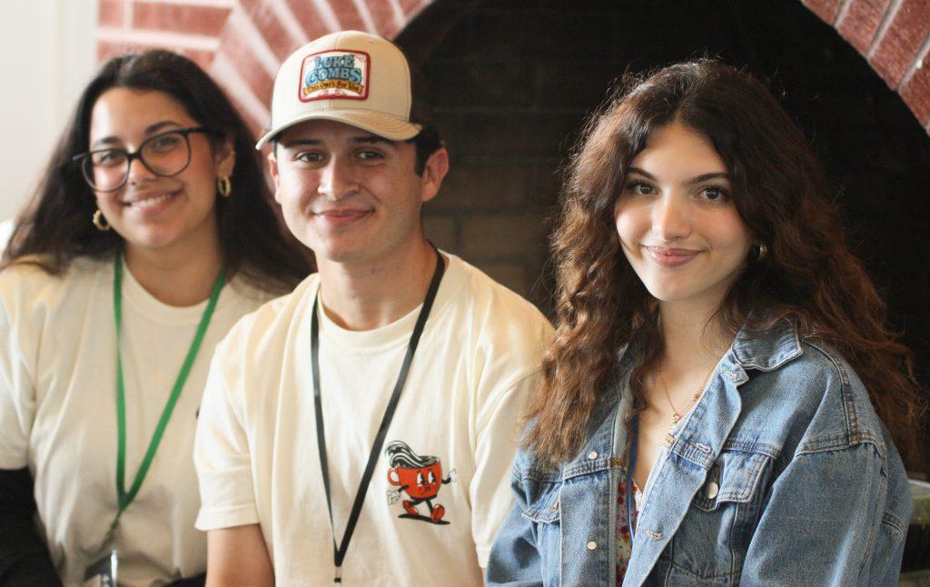 (From left) Student employees junior Mariah Hernandez, junior Steven Cordova, and first-year Sofia Preston, smile for a picture March 23, for Creative Cafe in the Fireside Room. RISE student employees alongside their program specialists and Dr. Bui Khanh, were responsible for putting the event together.