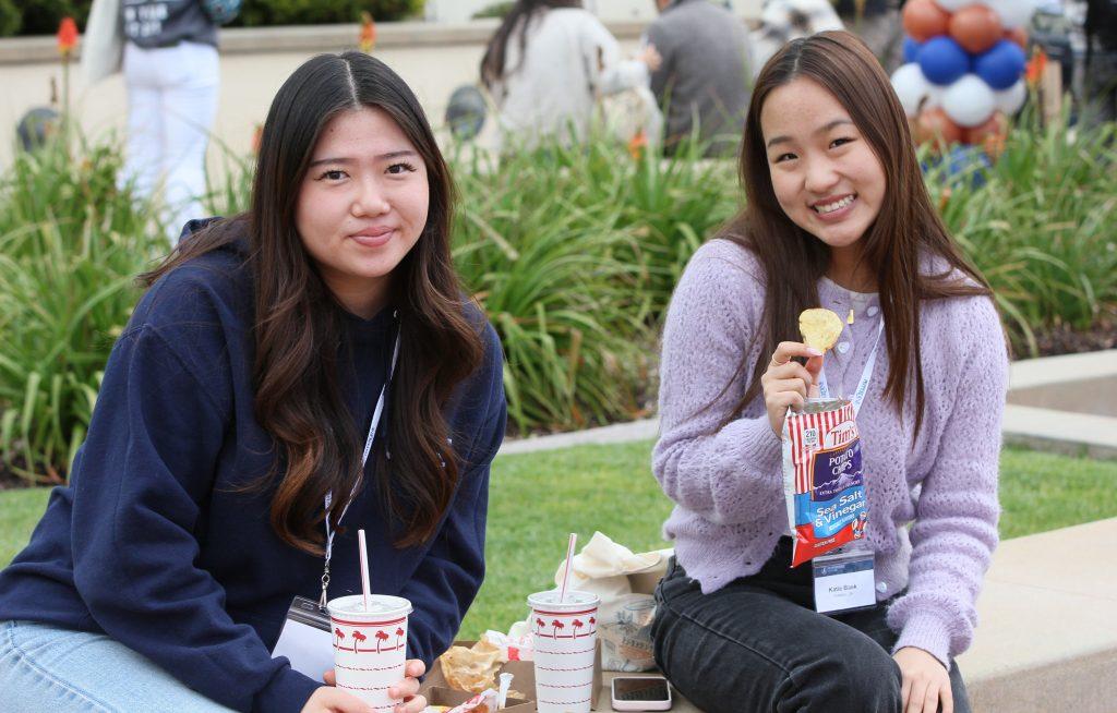 Admitted students sit and enjoy In-N-Out combos at Upper Mullin Town Square on April 5. This meal allowed future Waves to build community and explore campus. Photo by Olivia Schneider