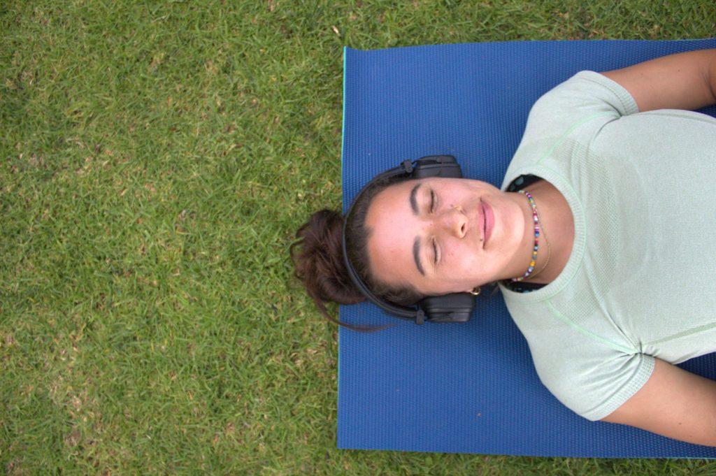 Sophomore Emma Monte lays back on a yoga mat on Main Campus. Monte said she began taking a Sabbath during her junior year of high school. Photo by Yamillah Hurtado