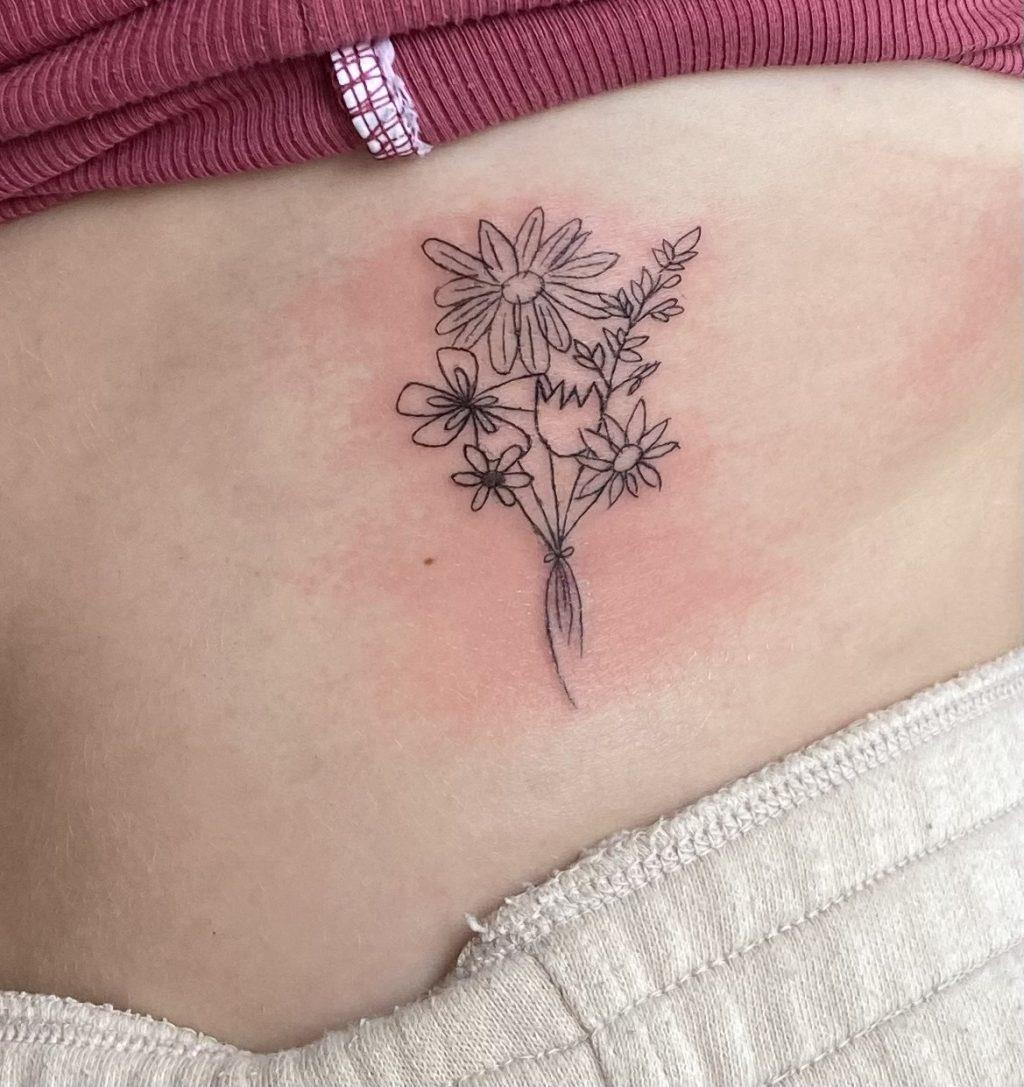 First-year Tabitha Vanderhost's favorite and most meaningful tattoo lies on her left side Oct. 11, 2022, in San Luis Obispo, California. Vanderhost said each of her family members drew one flower. Photo courtesy of Tabitha Vanderhost