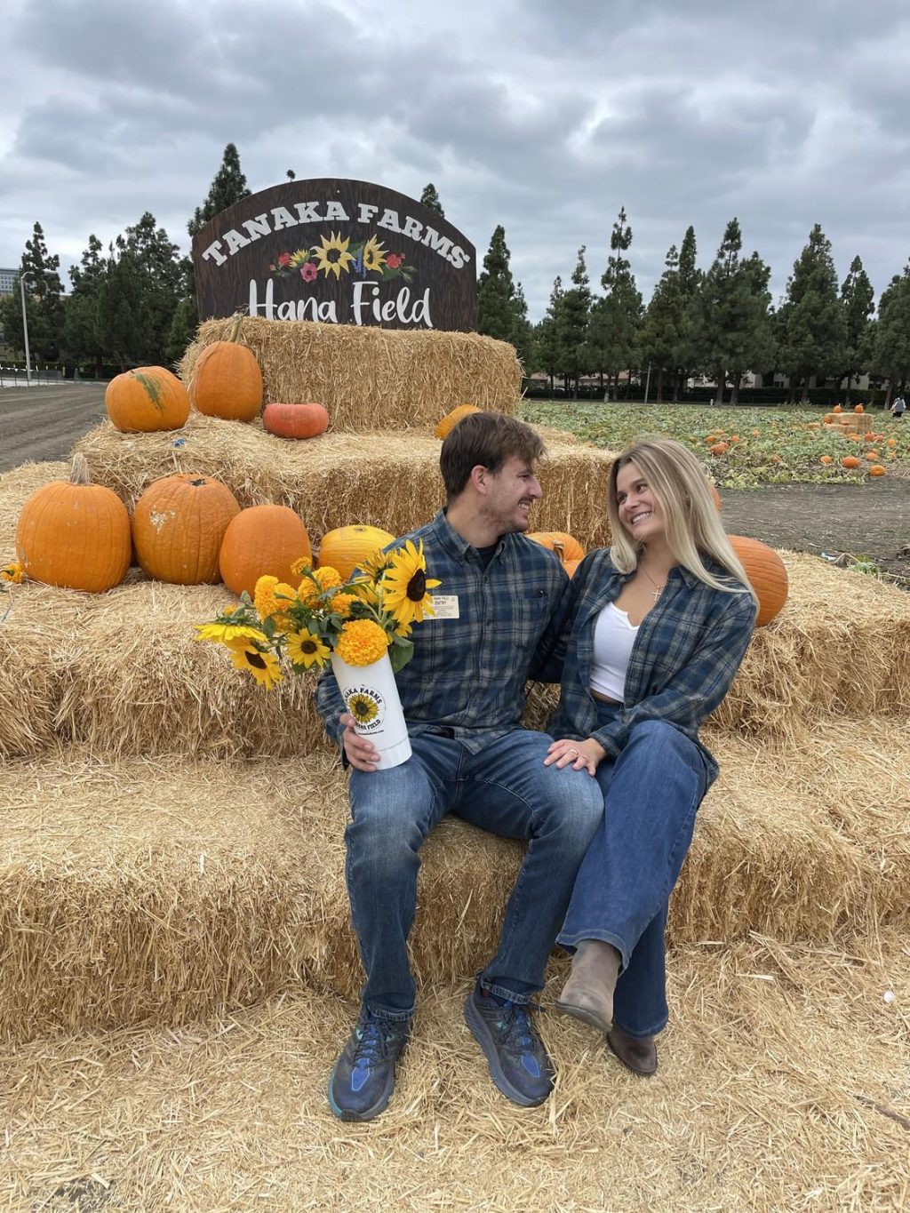 Olson and Landis sit on a haystack at a pumpkin patch. The pair said they have loved growing alongside one another throughout their time in college. Photo courtesy of Kira Landis