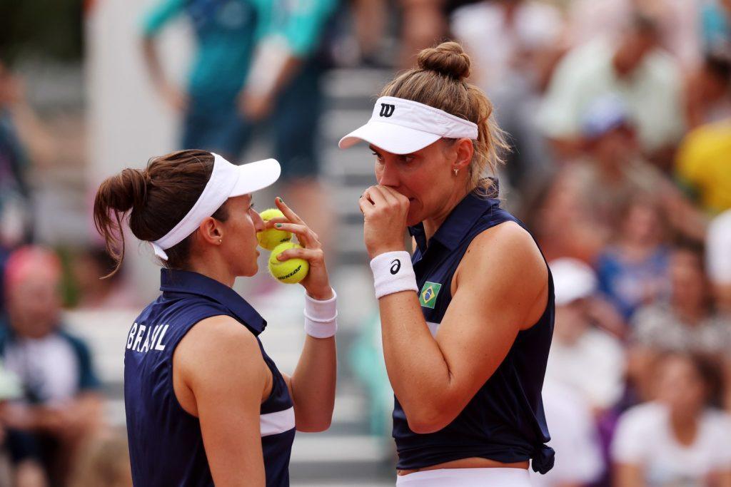 Luisa Veras Stefani and her teammate duo, Beatriz Haddad Maia, talking strategy during a match at the 2024 Paris Olympics. Stefani fell in the second round with duo Maia, previously finishing ninth at the '20 Olympics. Photo courtesy of Pepperdine Athletics