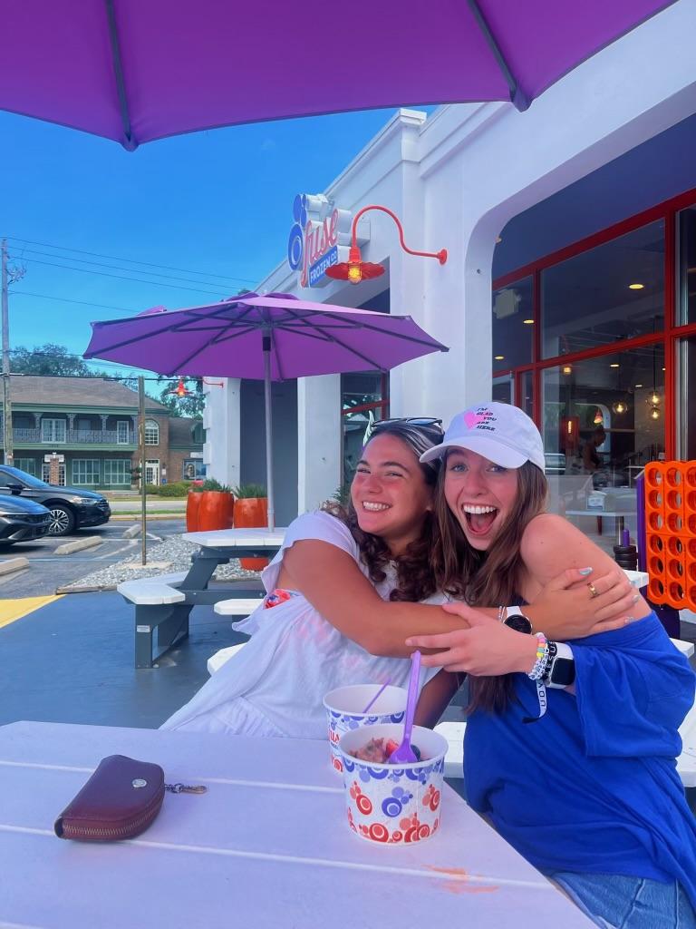 Sophomores Gabby Cabai and Lacey Reedy hug one another while eating frozen yogurt in Saint Simons Island, Georgia on July 19. Reedy said she felt lucky to show Cabai the places that are so special to her in the place she calls home. Photo courtesy of Gabby Cabai