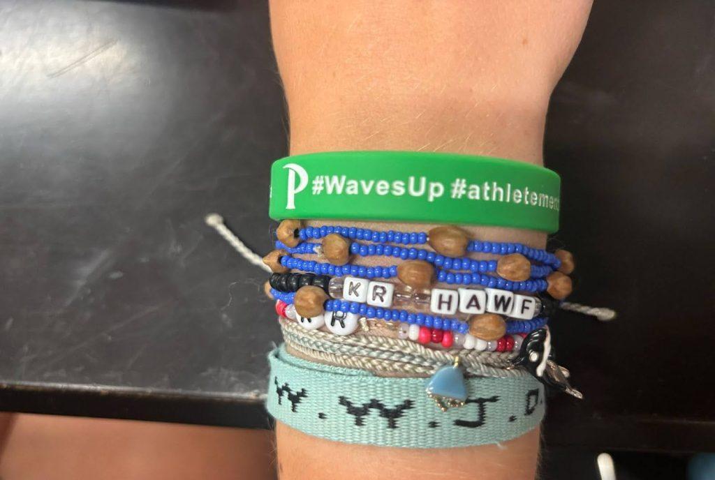 Kayla Renner, Pepperdine Women’s Cross Country freshman, wears her mental health awareness bracelet April 10. The bracelets are green, which is the mental health awareness color, and have the inscriptions #WavesUp and #athletementalhealth, Renner said. Photo by Emma Martinez