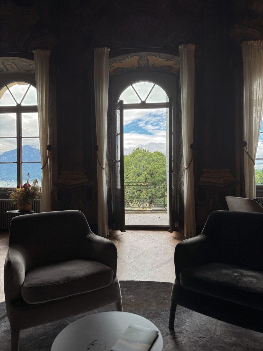 A glimpse inside the Grand Salon overlooking Lake Geneva and the Swiss Alps. The Grand Salon is an original foundational element of the château decorated with a fresco style.