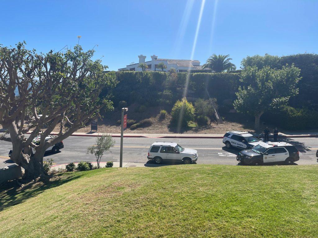 L.A. County Sheriff’s deputies surround a white SUV on John Tyler Drive on Wednesday afternoon after the SUV trespassed on Malibu’s campus. The driver had been seen with a BB gun pointed out the window while driving on PCH. Photo by Justin Rodriguez