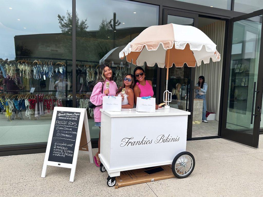 Abby Burnam (left), Soleil Velasco (middle) and Mireya Jewel (right) stand in front of the new store with their free popsicles Aug. 17. Velasco said the event was a great bonding activity for the three of them. Photo courtesy of Soleil Velasco