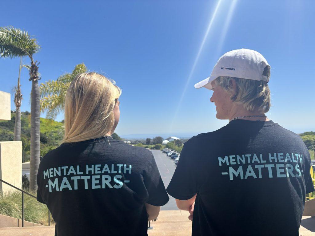 Kayla Renner, first-year Pepperdine Women’s Cross Country and Track and Field runner (left), and Kaleb McElfish, first-year Pepperdine Men’s Cross Country and Track and Field runner (right) wear their mental health matters shirts April 2024 at Firestone Fieldhouse. Both athletes said they support Pepperdine University and the West Coast Conference’s goal to increase awareness of student-athlete mental health. Photo courtesy of Emma Martinez