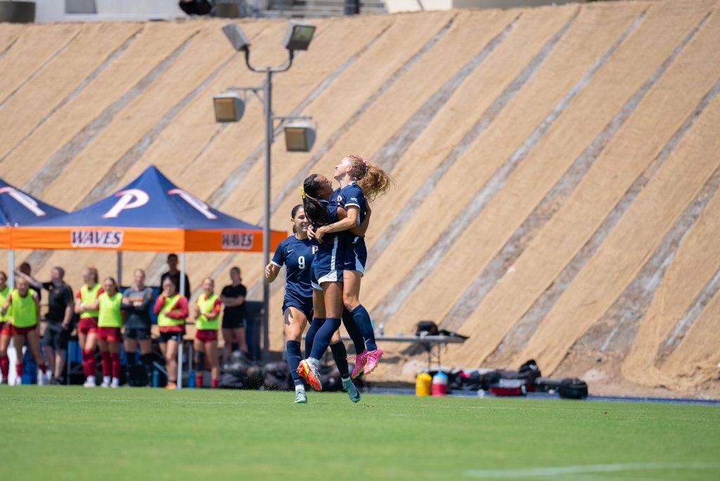 Members of Women's Soccer celebrate with each other after a goal against USC on Aug. 25, at Tari Frahm Rokus Field. Multiple members of the team said the noticeable home crowd gave them energy early in the match.