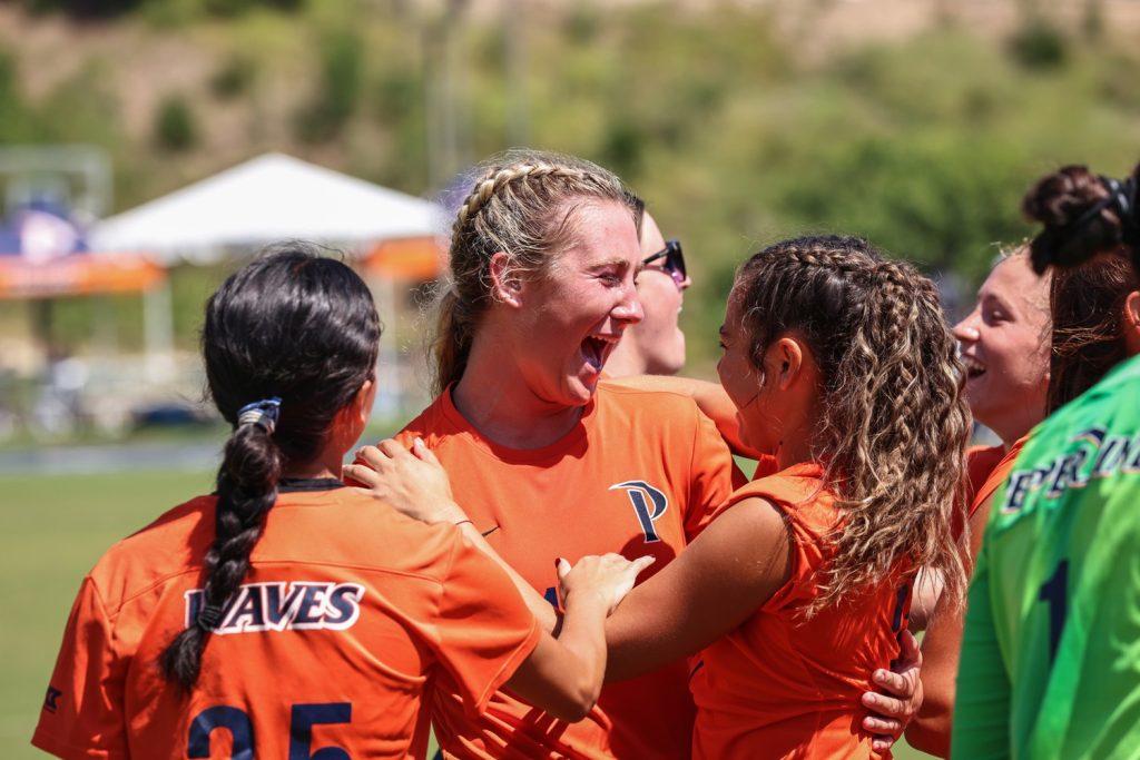 Sophomore defender Peyton Leonard is embraced by her team after her goal in the game against UCLA on Sept. 1 at Tari Frahm Rokus Field. Her goal ensured the win for the Waves in the final score of 1-0.