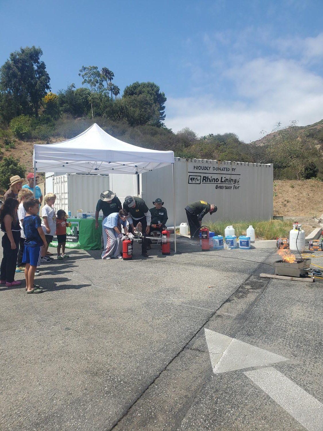 A young girl puts out a fire at the Safety and Preparedness Fair at Malibu City Hall on Sept. 15. Children were trained by the Malibu Community Emergency Response Team to use a fire extinguisher.