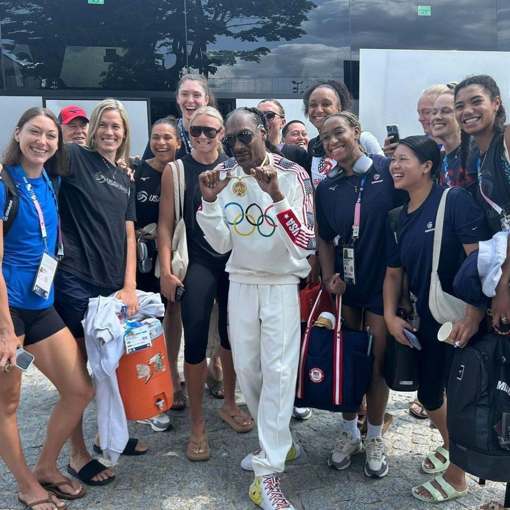 Head Coach Emeritus Marv Dunphy and Team USA Women's Volleyball pose for a picture with Snoop Dogg at the 2024 Paris Olympics. Snoop Dogg is one of many celebrities Dunphy met in Paris, even snapping a photo with Billie Jean King. Photo courtesy of Pepperdine Athletics