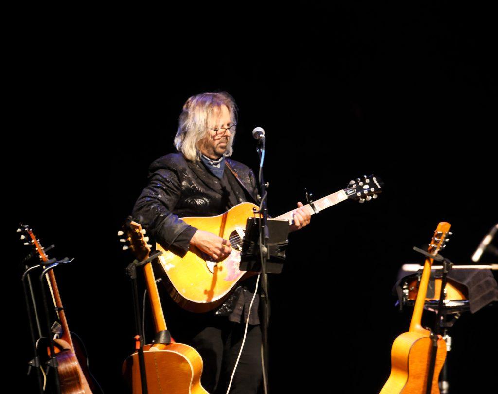 Dave Blasucci strums an acoustic guitar Sept. 13. The guitarist is also the group's road manager.