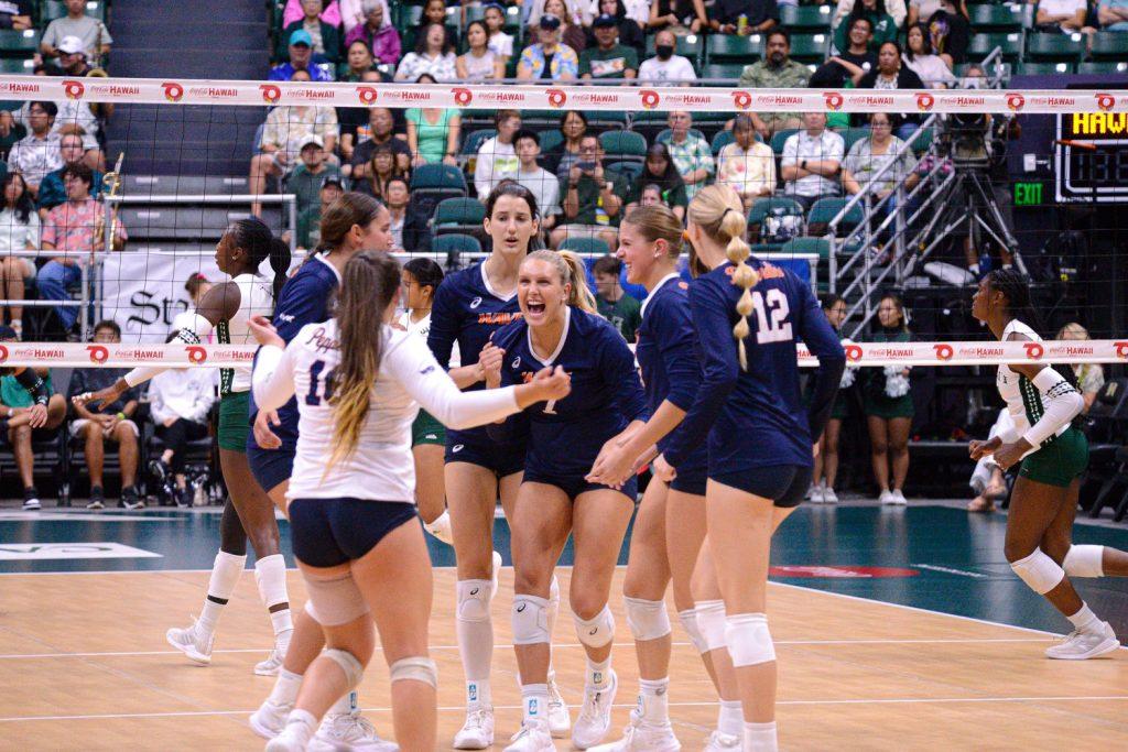 Pepperdine Women's Indoor Volleyball celebrates after scoring a point against Hawaii on Sept. 6 at SimpliFi Arena at Stan Sheriff. Seen in the middle of the huddle, senior outside hitter Birdie Hendrickson had 14 kills and helped the Waves beat the Rainbows for the first time since 1997. Photos Courtesy of Pepperdine Athletics