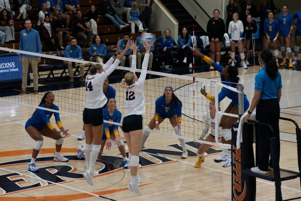 Junior middle blocker Kenadie Patterson and freshman outside hitter Maggie Beauer block a kill attempt from sophomore outside hitter Torrey Stafford on Sept. 13, at Firestone Fieldhouse. The Waves had 12 blocks and 39 digs in the match.